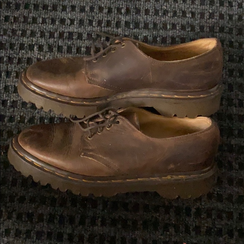 Dr. Martens distressed brown leather shoes.